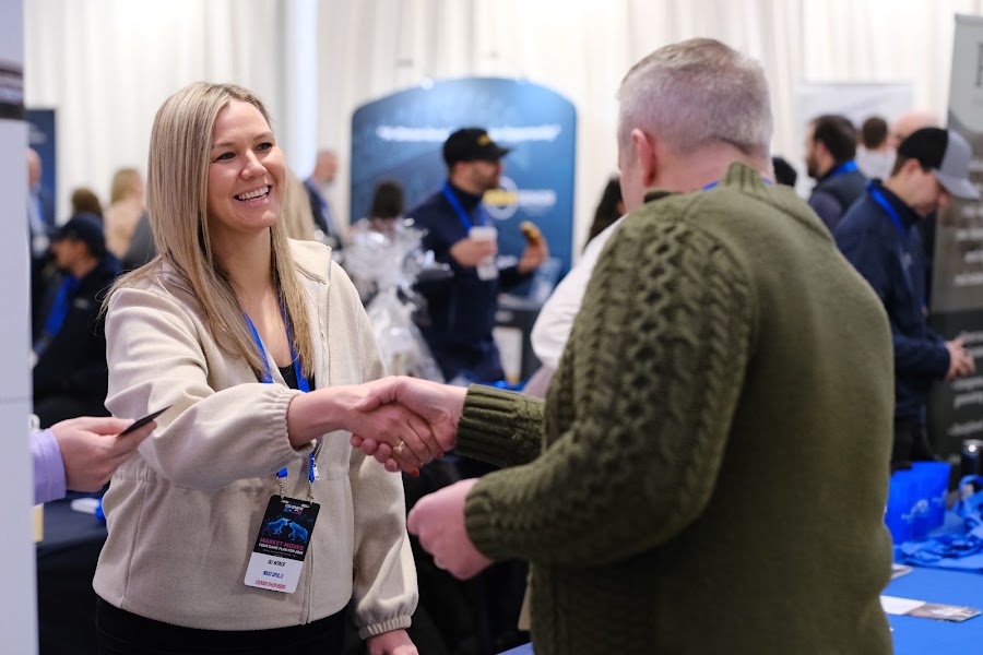 Two attendees shaking hands at Colorado RE•CON