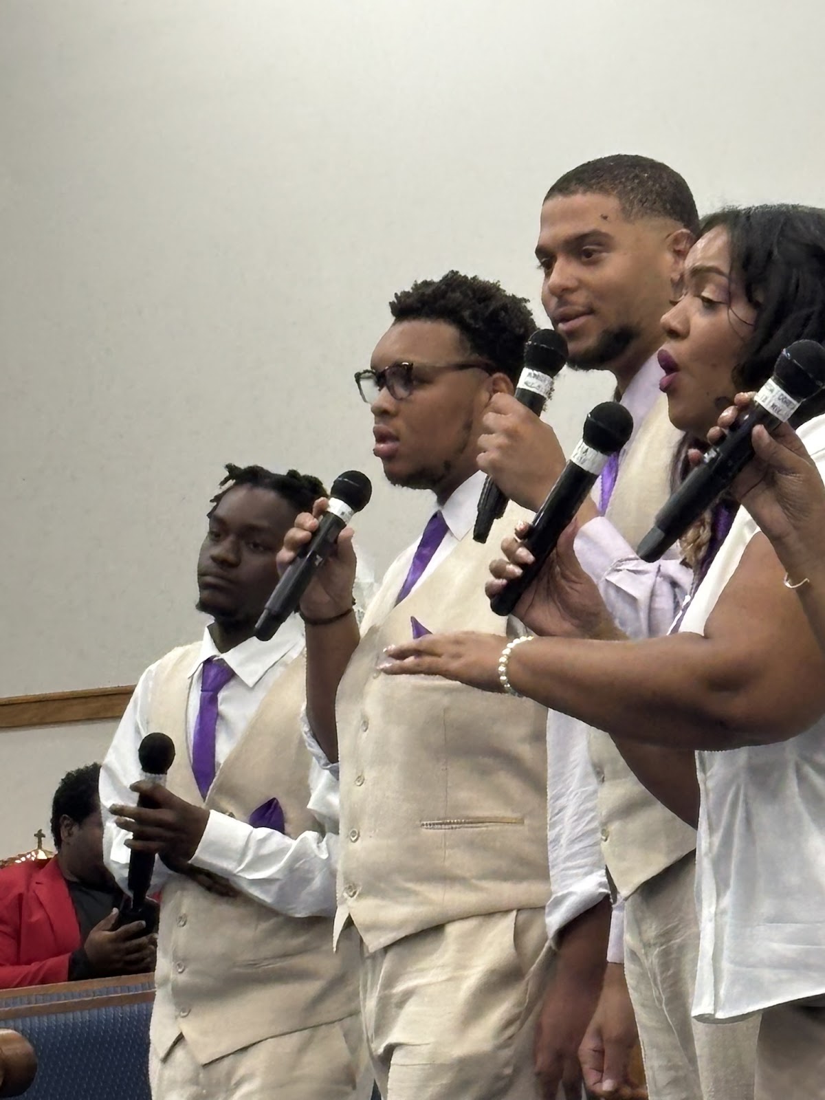 Youth vocal group in beige suits with purple ties performing at Sharpe Road Homecoming Concert 2026