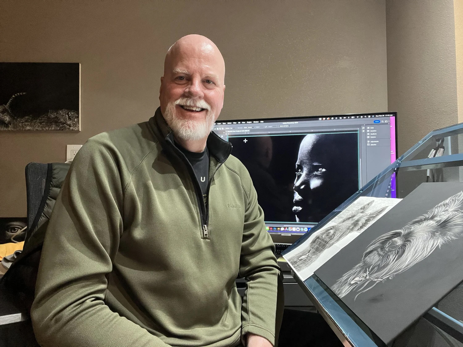 Steve Hammond in front of his scratchboard art workspace