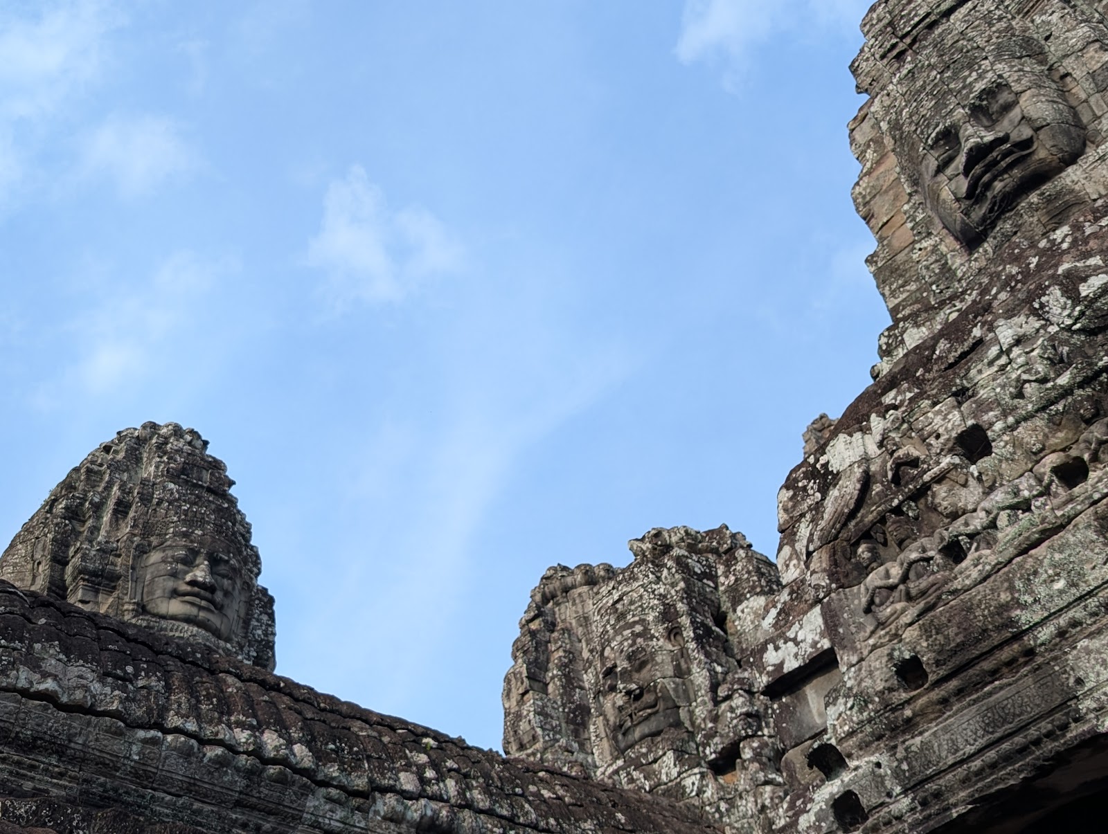 Three more towers of the temple showing carved faces on each