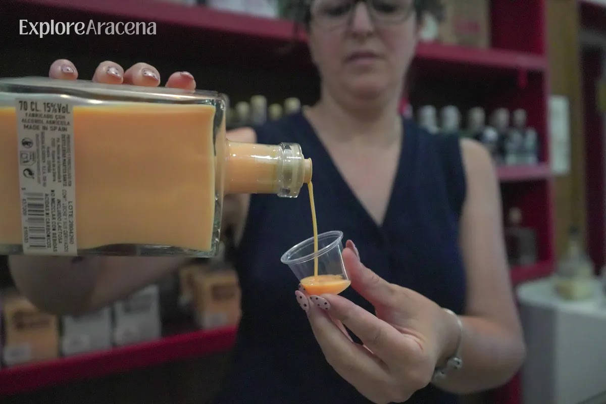 A member of the Martes Santos team pours a tasting of passionfruit cream liqueur for visitors inside the distillery.