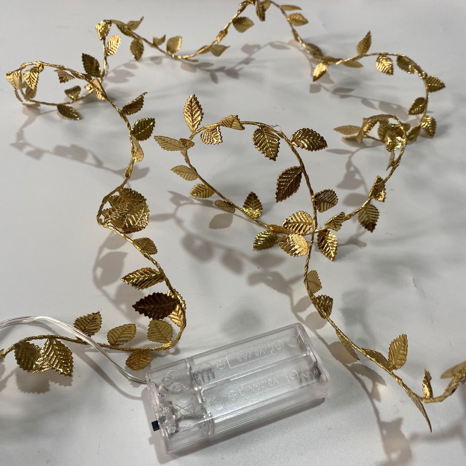 LED string lights with artificial leaves
