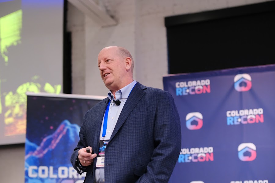 Speaker on stage at a past Colorado RE•CON event