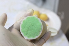 Cách làm bánh dẻo lạnh Singapore: Sau 1 giờ, bạn lấy ra chia bột thành những viên tròn cỡ 30g, ấn dẹt ra, cho viên nhân đậu xanh vào giữa. Bọc kín nhân, cho vào khuôn, ấn chặt tay, làm cho hết phần bột và nhân.