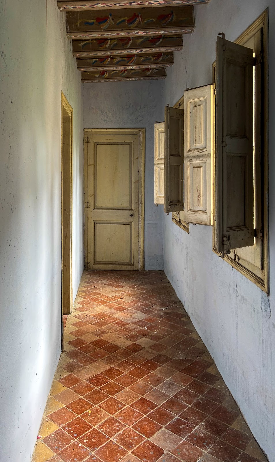 Original interior corridor at Font de l'Oca wellness retreat — 19th-century painted beams, Catalonia