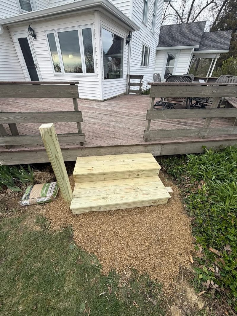 New deck stairs were rebuilt by Precision Home Services, leading from a deck to the lawn in Woodford County.