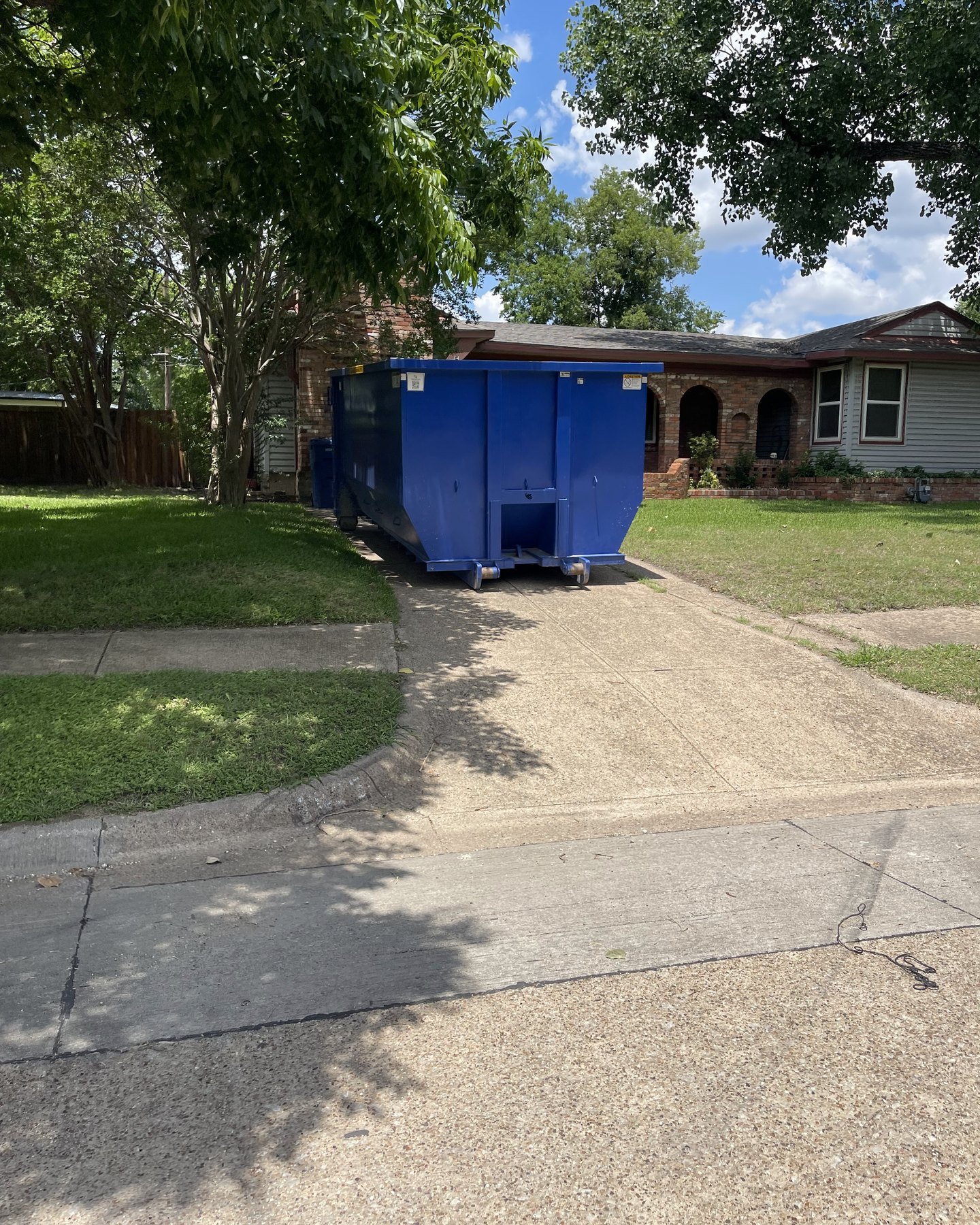 Roll-off dumpster in a residential driveway