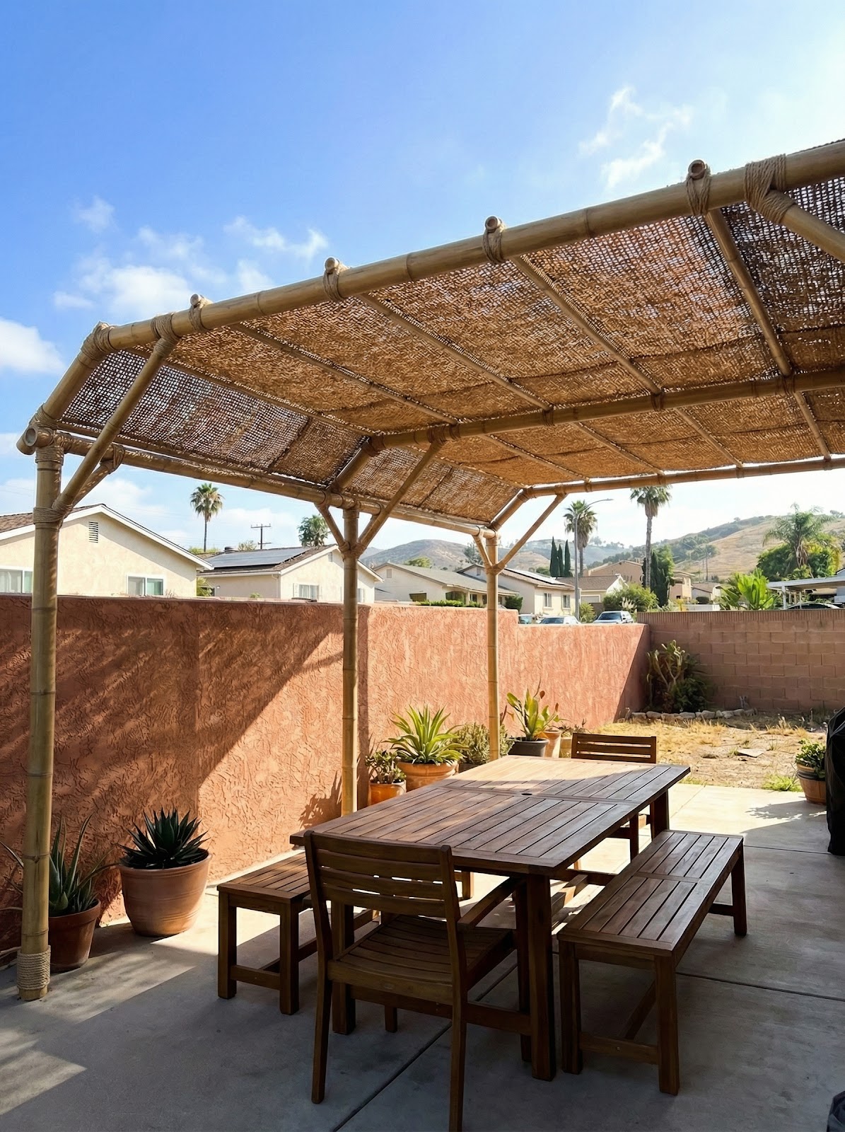 Bamboo pergola with woven coir shade panels for outdoor dining