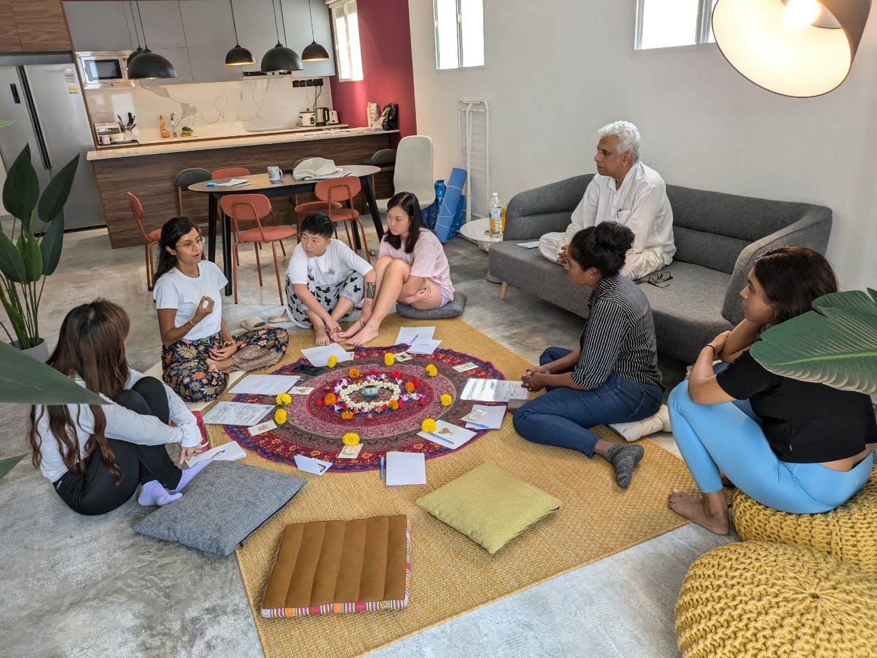 A small group sharing circle, held gently in natural light