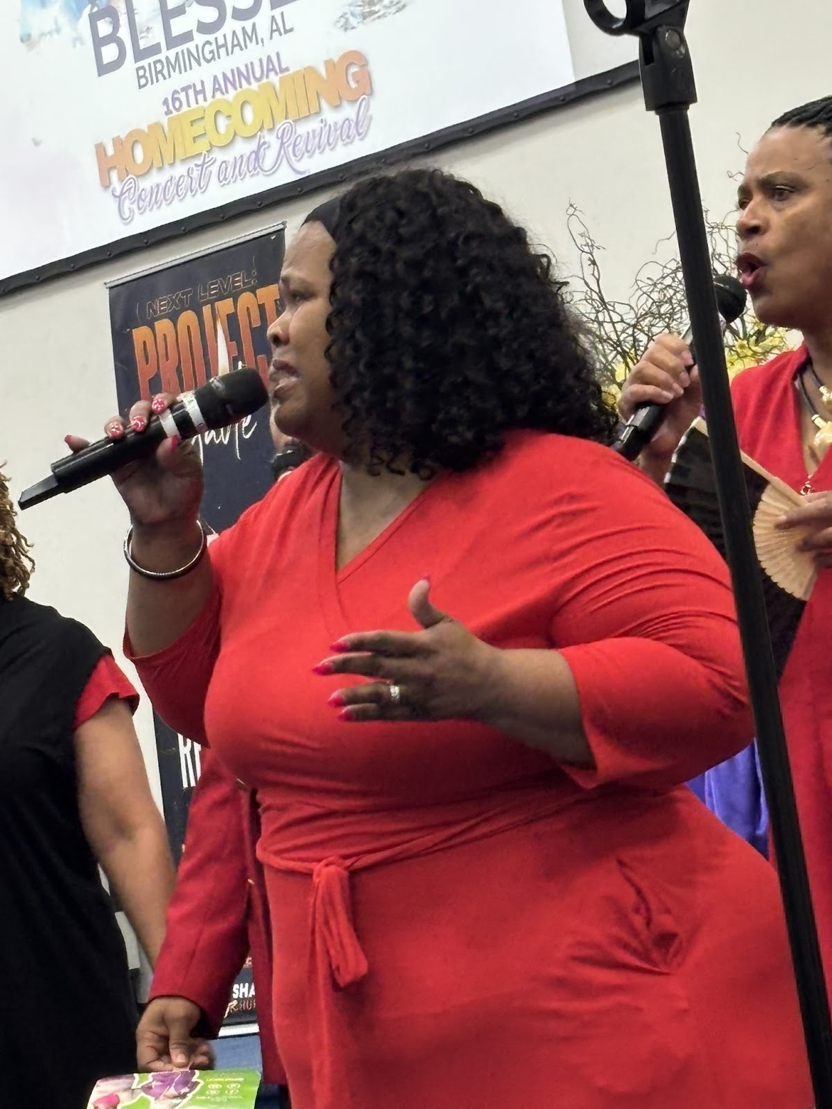 Gospel singer in red dress at microphone during Sharpe Road Church Homecoming Revival 2026