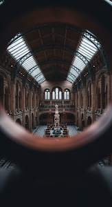 Dramatic View of Grand Victorian Museum Hall Through Blurred Copper Railing