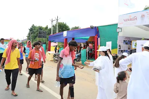 Young pilgrims stream past the camp.