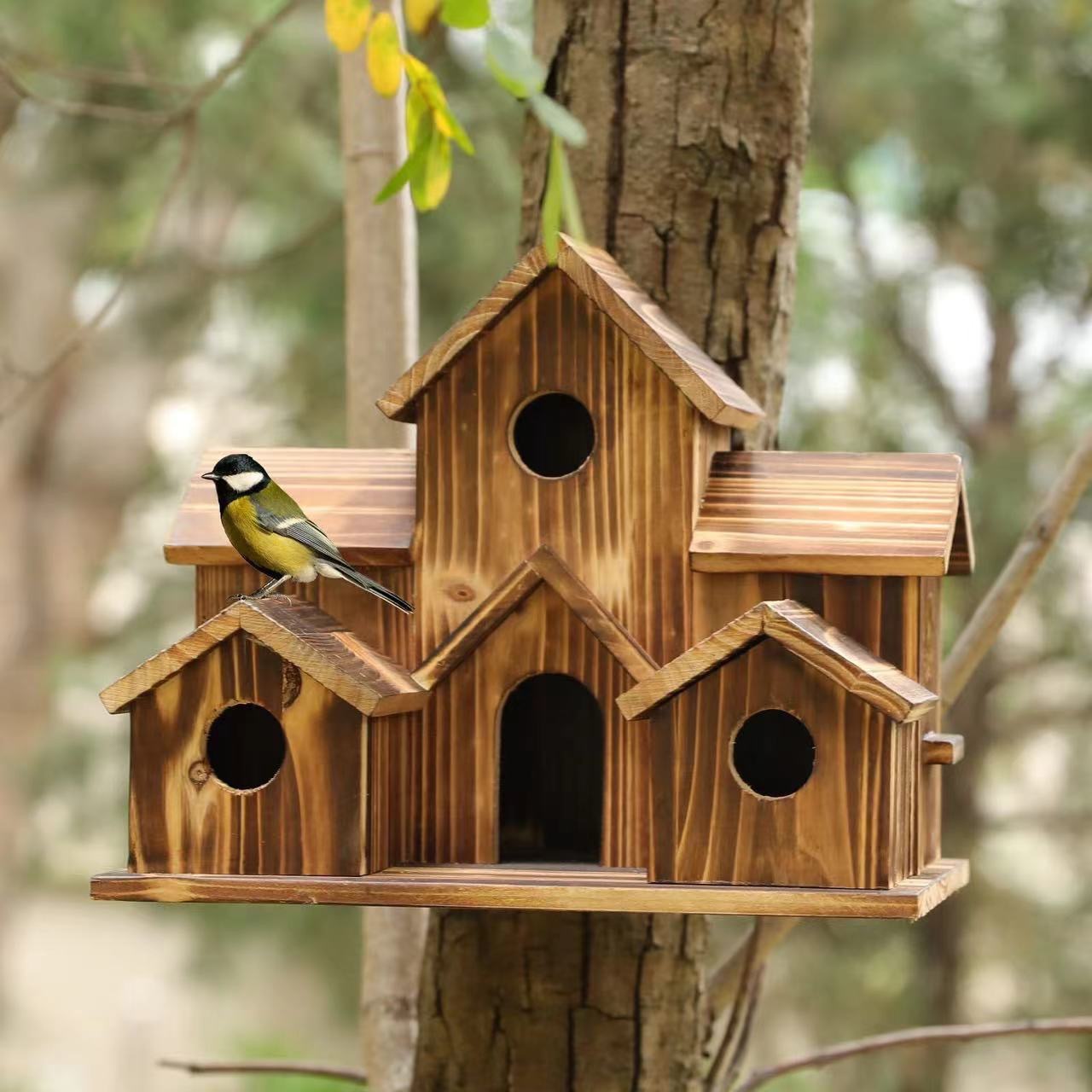 Wooden birdhouse in country house style for the garden