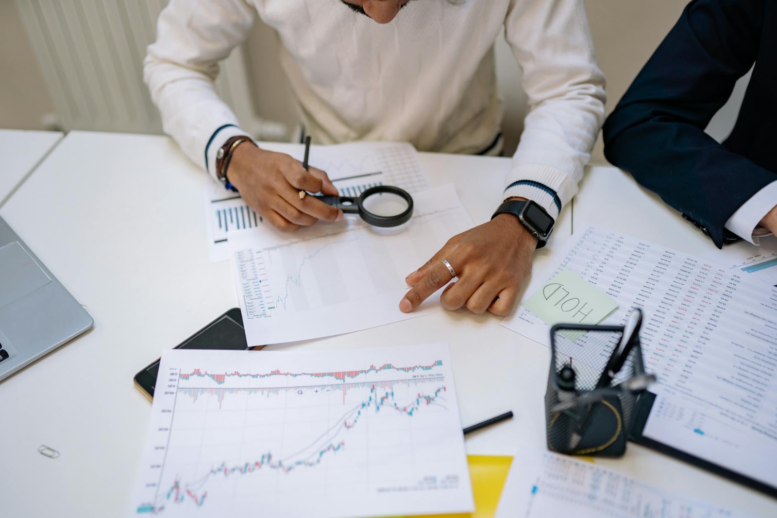 Financial analyst meticulously examining investment charts with AI market price data overlay, highlighting crucial investment trends.