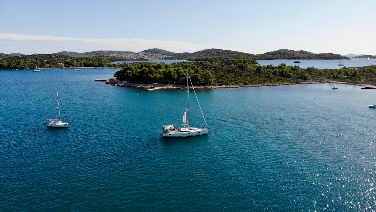 Two yachts anchored in a wide bay