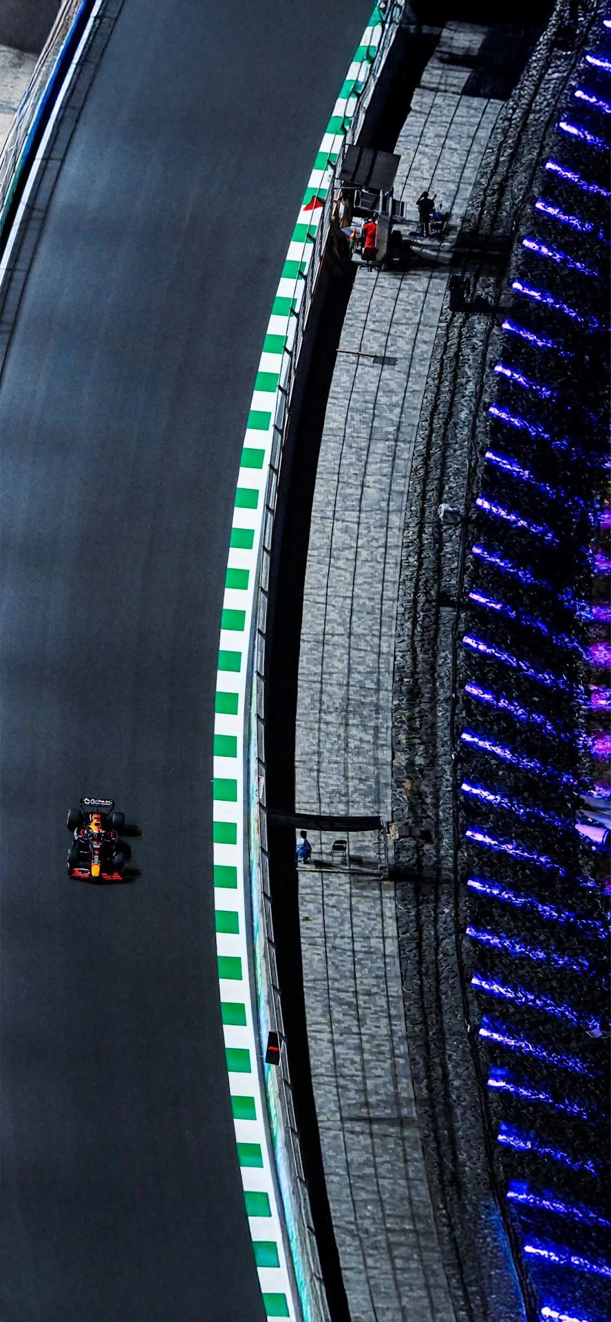 F1 Race Car Speeding on Track with Neon Lights at Night - Free 4K mobile Wallpaper
