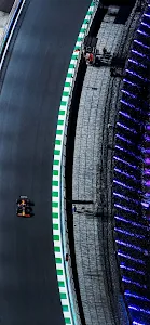 F1 Race Car Speeding on Track with Neon Lights at Night