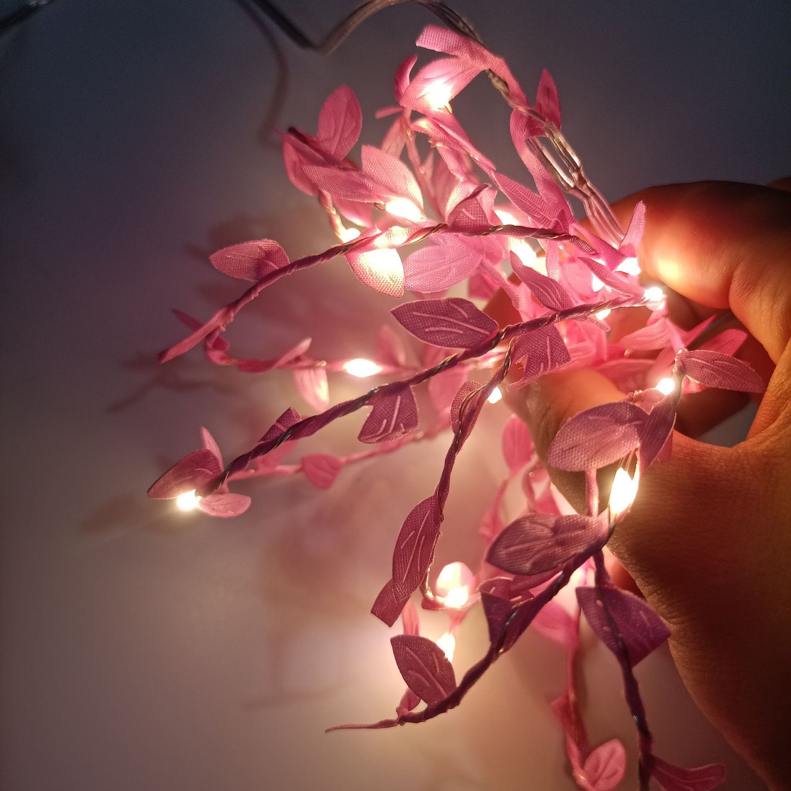 LED string lights with artificial leaves