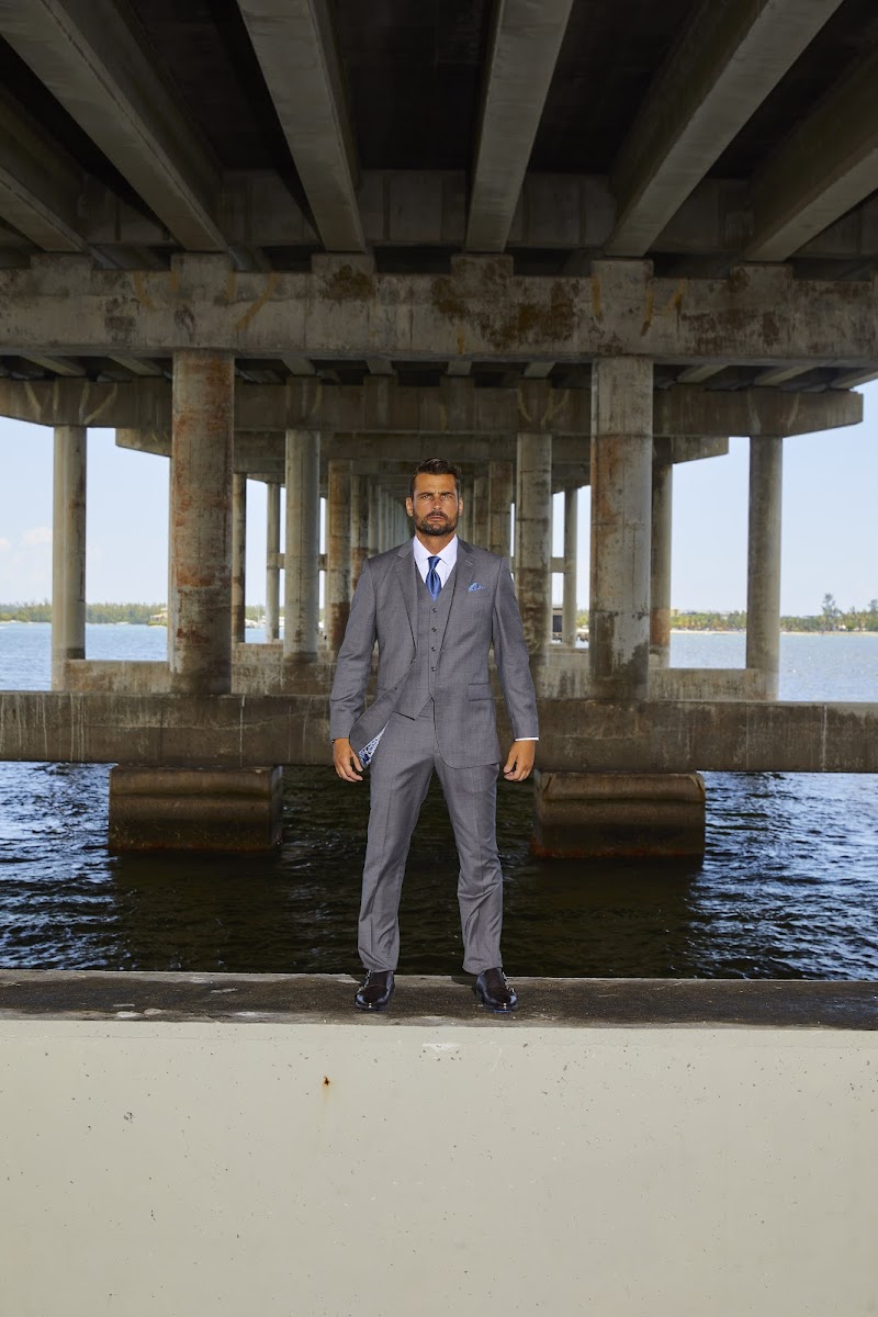 A groom wearing a grey three piece wedding suit that balances the shoulders, waist, and overall silhouette.