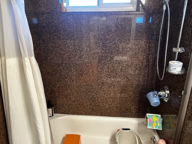 Tub and shower with granite-look surround