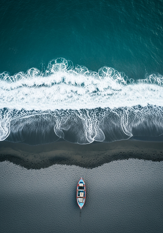 Fishing Boat on Dark Sand Beach