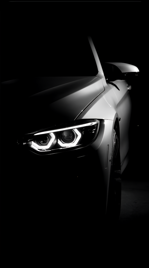 White Sports Car Headlight in Dark Studio Setting
