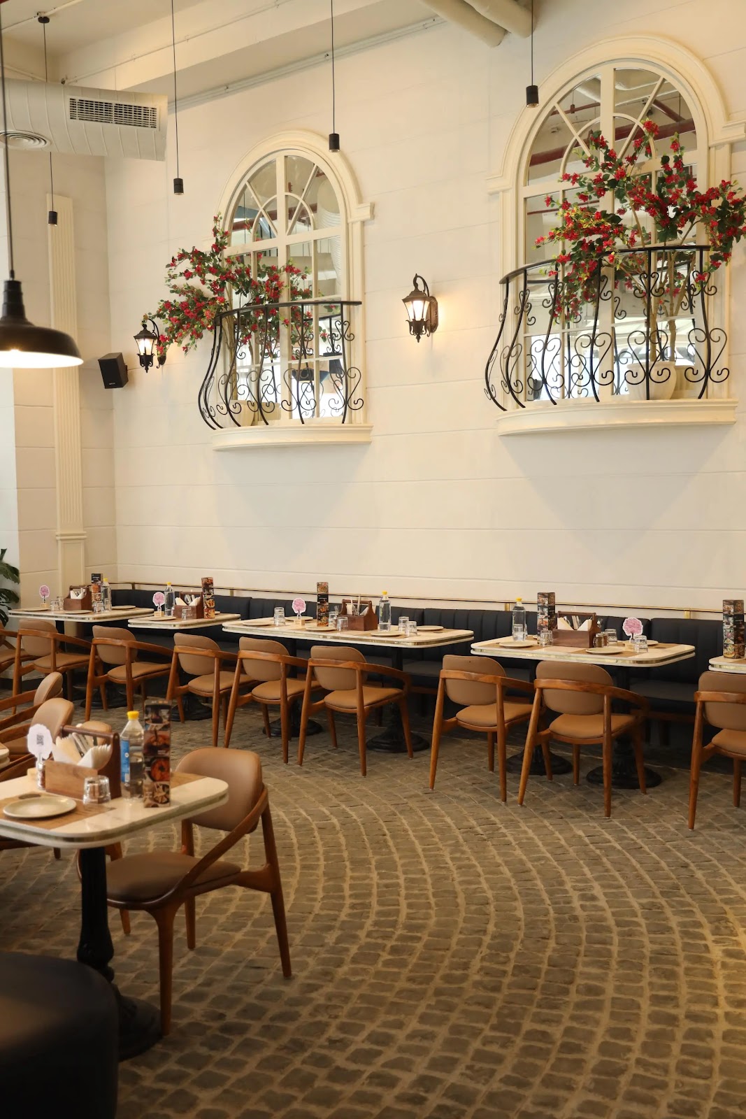 Spezia Bistro wide interior with arched windows and bougainvillea