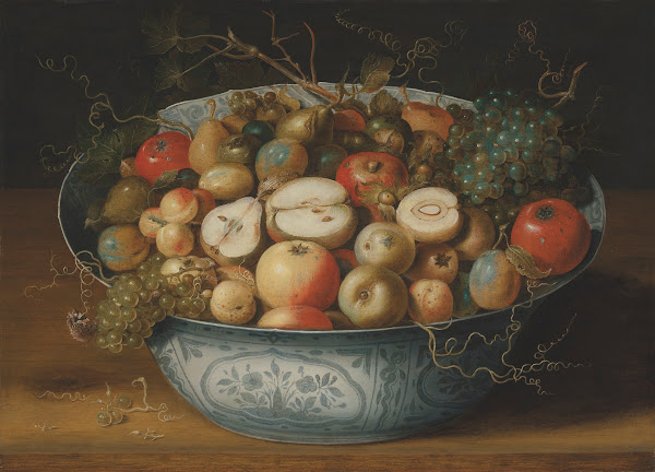 A Chinese bowl with apples plumbs grapes and nuts