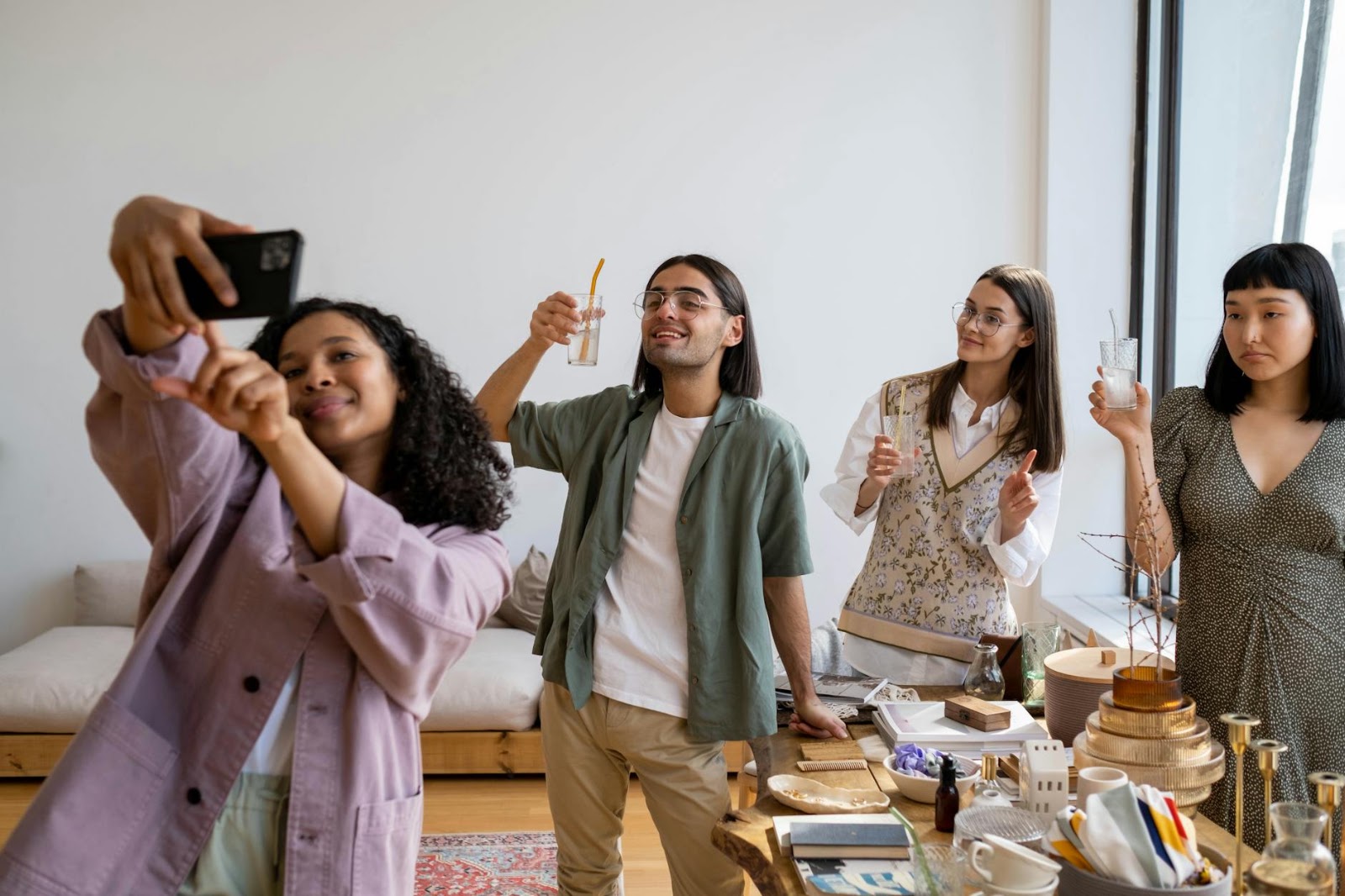 Diverse group of friends enthusiastically watching and reacting to live social media shopping trends on a smartphone.