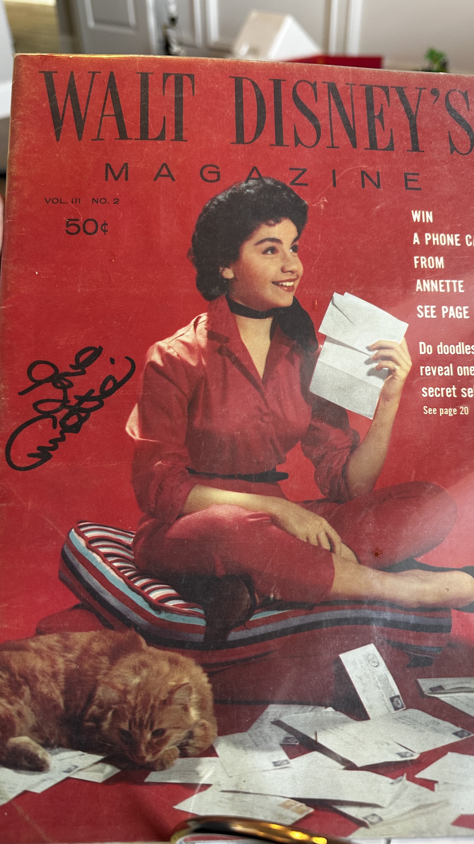 February 1958 Walt Disney's Magazine Vol. III No. 2 cover featuring Annette Funicello seated on a striped cushion surrounded by fan mail, with her black ink autograph reading "Love, Annette" on the left side