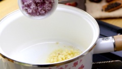 Trong lúc chờ cá nục, mình sẽ làm nước sốt cà chua. Cho vào nồi 2 muỗng canh dầu ăn, bỏ hành tím và tỏi băm vào phi vàng thơm. Tiếp theo cho phần cà chua đã cắt hạt lựu vào, xào đều tay cho cà chua mềm nhừ.