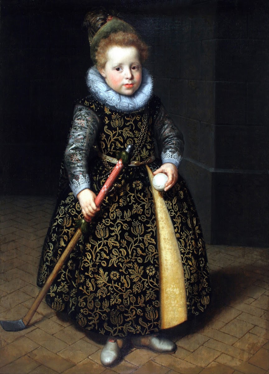 Portrait of a four year old boy with a club and ball