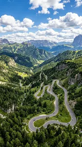 Aerial Perspective of a Winding Mountain Road Through Dense Forest