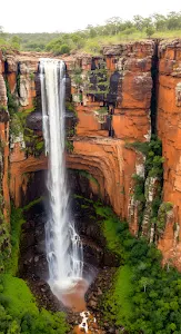 Majestic Waterfall Plunge into Red Sandstone Gorge