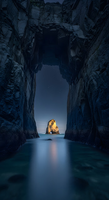 Dramatic Sea Cave View of Illuminated Sea Stack - Free mobile Wallpaper