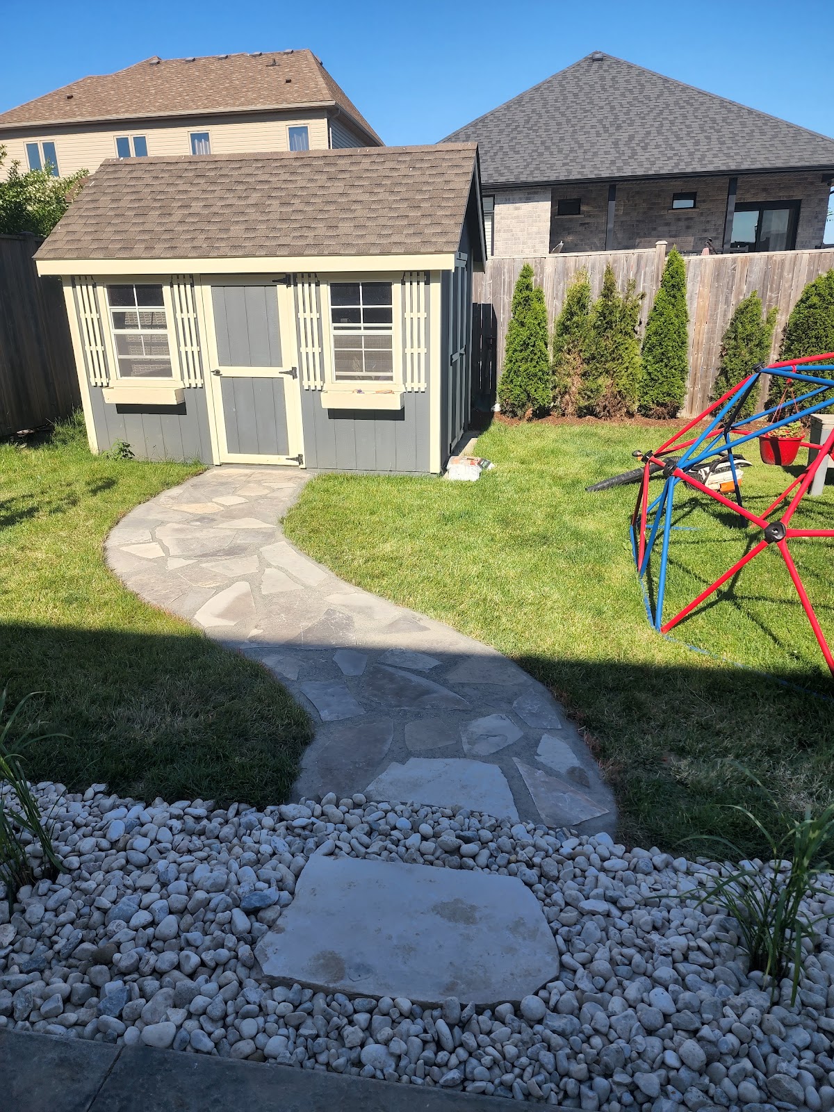 Lush backyard garden and softscape layout in London, Ontario