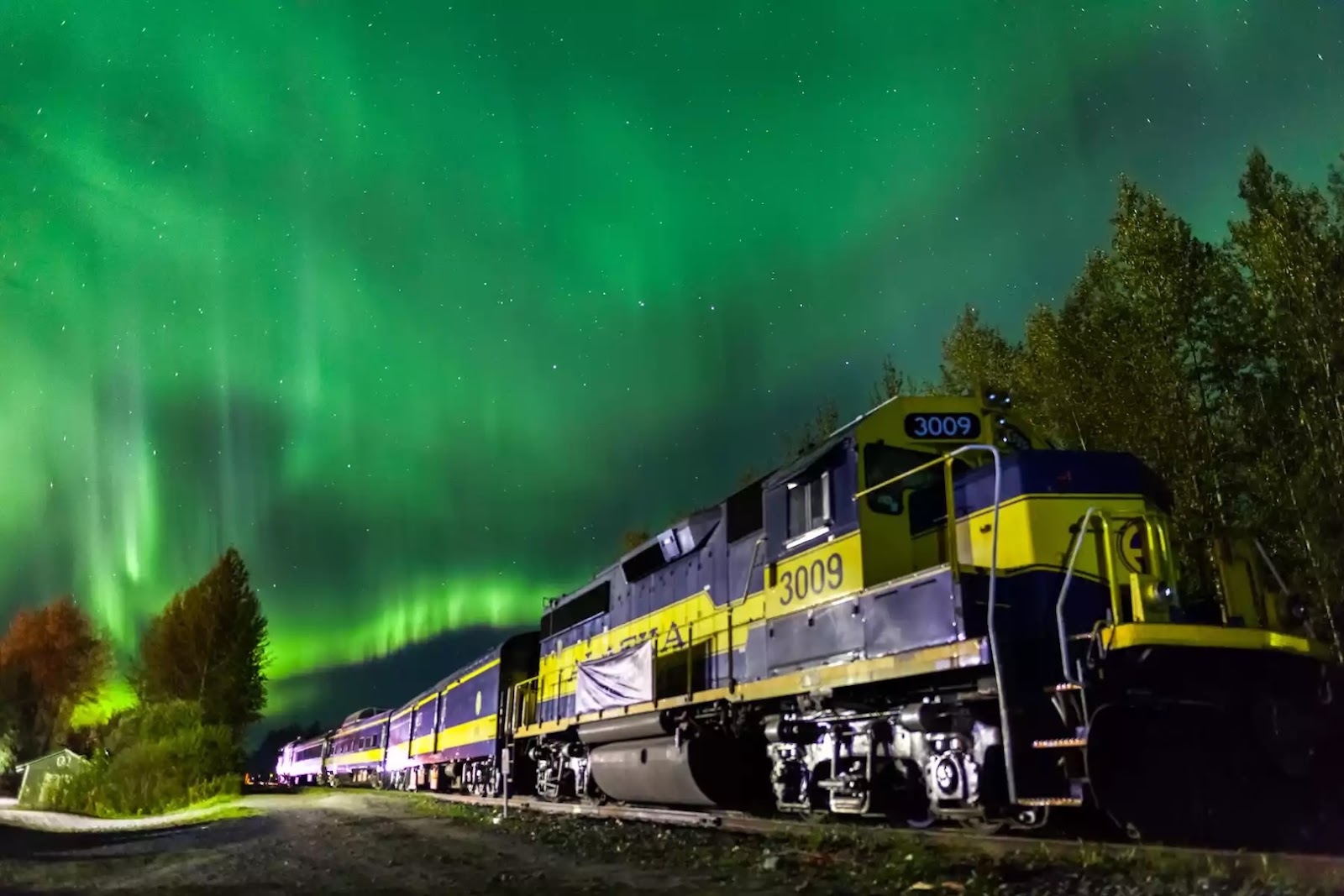 Alaska Railroad Aurora Winter Train traveling through a snowy Alaska landscape.