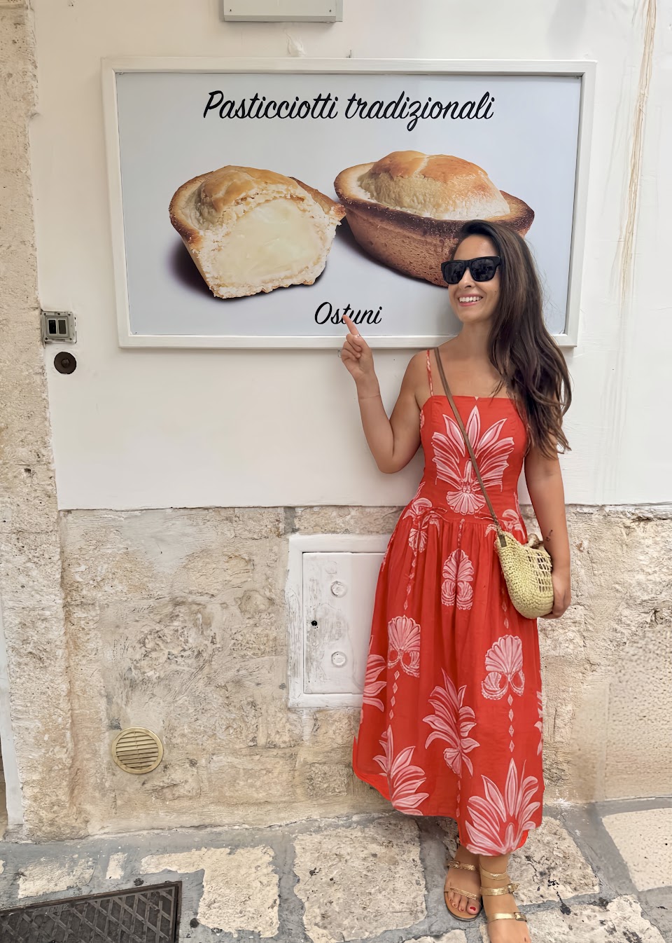 Vera Fritsch in Ostuni, Italy, pointing at the pasticciotto