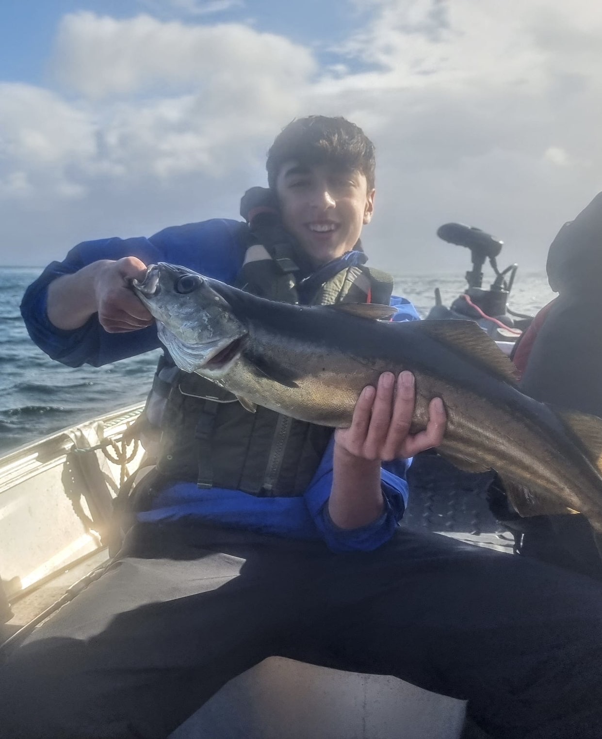 Alex Amir with a large Pollack caught from a boat off the Isle of Skye