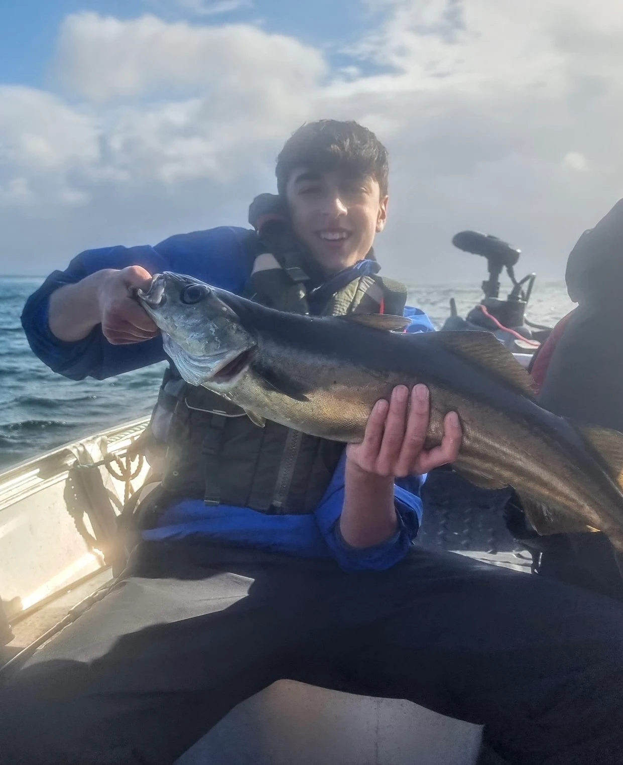 Alex Amir with a large Pollack caught from a boat off the Isle of Skye
