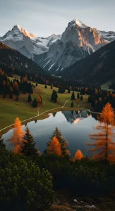 Autumn Larch Trees Reflected in Calm Alpine Mountain Lake