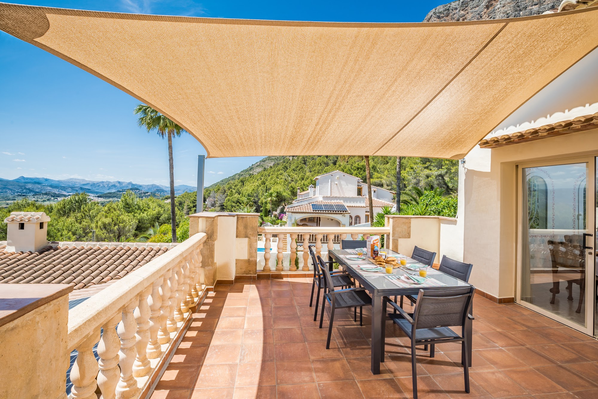 Shaded outdoor lounge under a sail