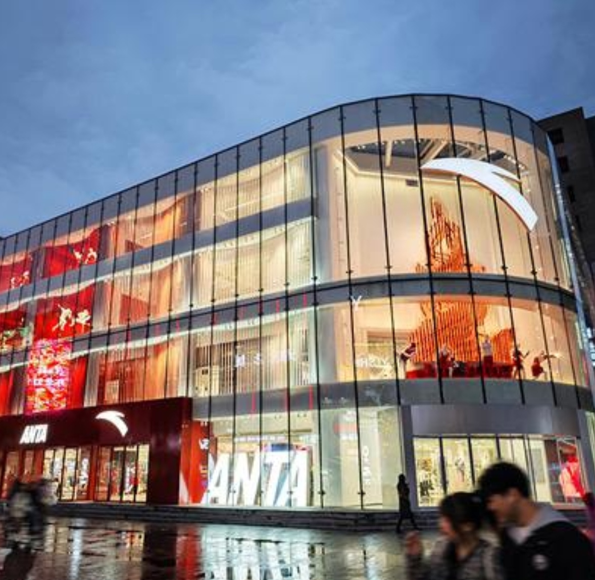 Xtep store window showcasing basketball footwear and sportswear on Beijing Road