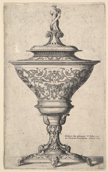 Ornate goblet on feet of masks 1645
