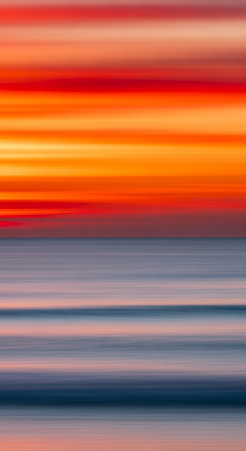 Abstract Intentional Camera Movement Photo of Vibrant Orange Sunset Over Blue Ocean - Free mobile Wallpaper