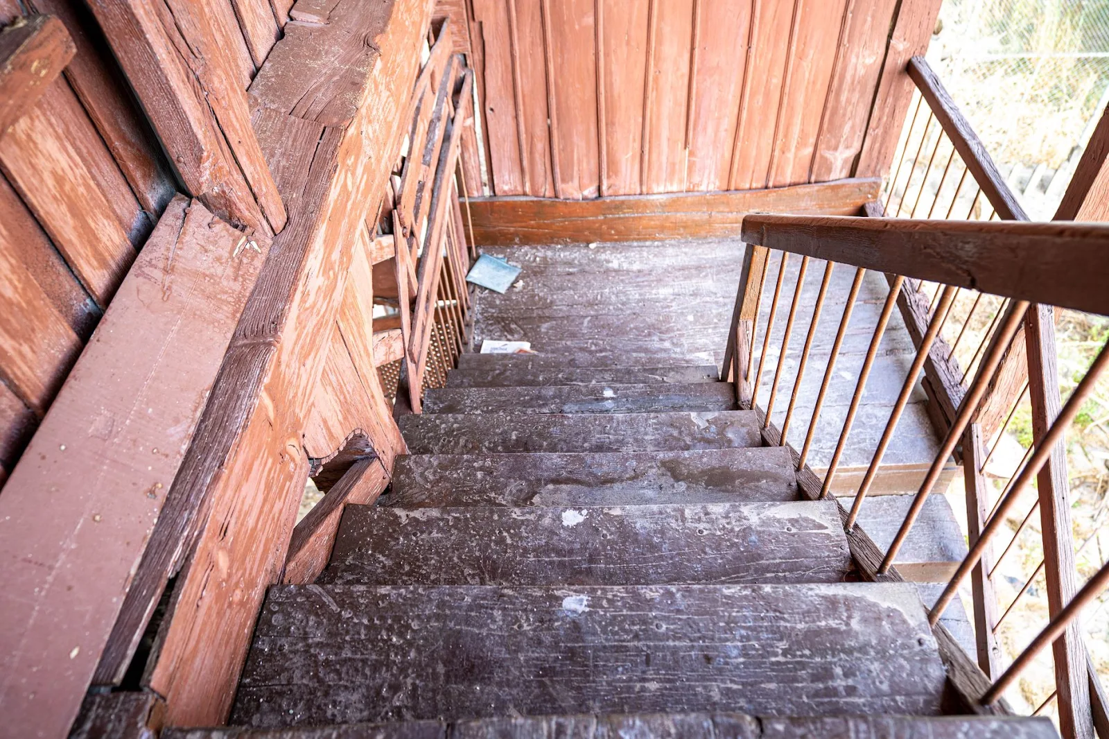 Explore the rustic charm of an abandoned building with this neglected wooden staircase.