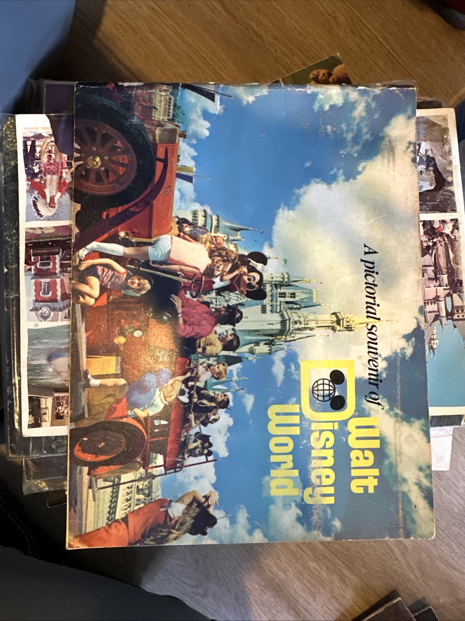 Oversized early 1970s Walt Disney World pictorial souvenir softcover book with blue starry sky, Cinderella Castle, and costumed Mickey Mouse on the cover