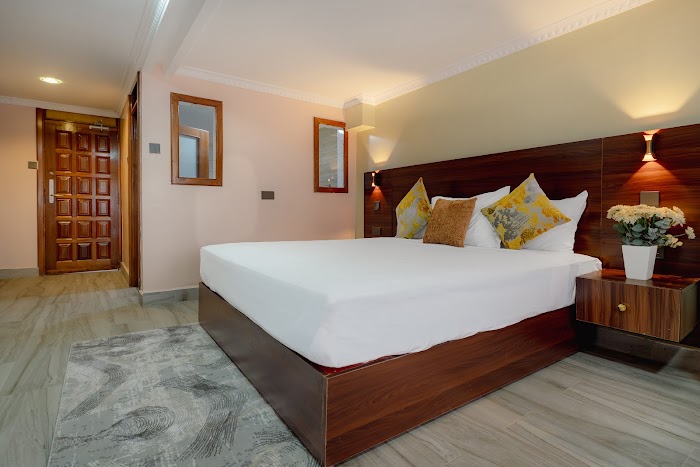 Room 3 bed and workspace Karen Plains Hotel
