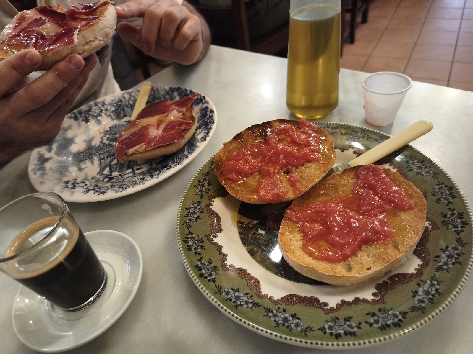 Two tostadas and Americanos served for breakfast at Taberna Rincón de Juan in Aracena.