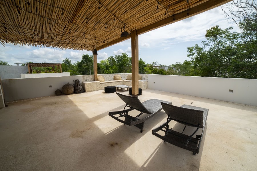 Shaded terrace with loungers beside the pool